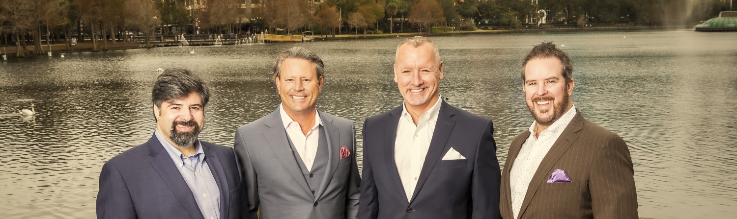  a picture of the Owners and founding team at Trova standing with Lake Eola and the iconic fountain of Orlando in the background.